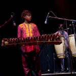 Sona Jobarteh&rsquo;s 14-year-old son, Sidiki Jobarteh-Codjoe, playing onstage with his mother
