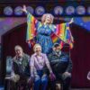 Dame Maureen Lipman as Allegra stands above John Middleton as Ronen, Elizabeth Bower as Anna and Bailey Patrick as Officer Rogers during a colourful musical number.