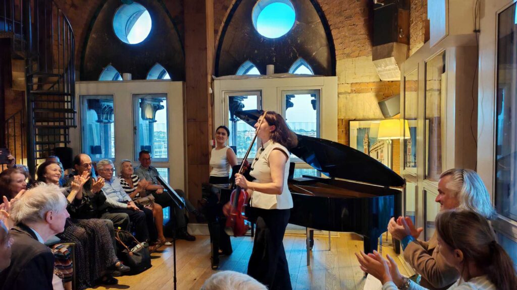 Ezo Sarıcı and Deniz Cengiz of Duo Ekeš receiving applause at St Pancras Clock Tower